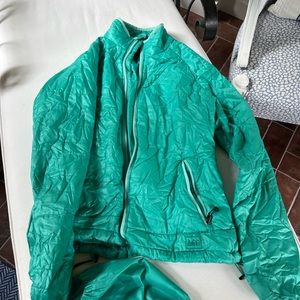 Rei brand packable jacket.  Wind proof and waterproof.  Runs small